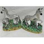 A pair of 19th Century Staffordshire hollow bottom Zebra figures