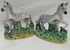 A pair of 19th Century Staffordshire hollow bottom Zebra figures