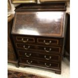 An Edwardian mahogany bureau with banded inlaid decoration and galleried top with two short over
