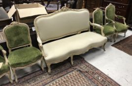 A 19th Century cream painted and gesso decorated salon sofa in the Louis XV taste raised on