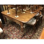 An early Victorian mahogany extending dining table the rounded rectangular top with extra leaves