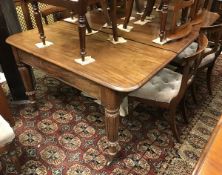 An early Victorian mahogany extending dining table the rounded rectangular top with extra leaves