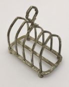 A George V silver four section toast rack of typical form (by Goldsmiths & Silversmiths Company