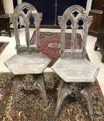 A pair of Victorian Gothic revival style limed oak panel seated hall chairs