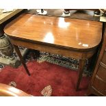 An early 19th Century mahogany fold over card table on square rosewood strung supports