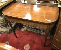 An early 19th Century mahogany fold over card table on square rosewood strung supports