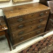 A 19th Century oak chest of four long graduated drawers to bracket feet
