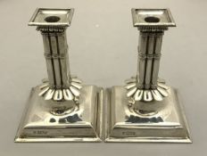 A pair of Edwardian silver cluster column candlesticks,