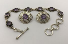 A modern silver and amethyst bracelet and earrings set