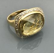 A 9 carat gold set dress ring with large citrine and diamonds