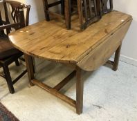 A 19th Century Continental pine drop-leaf dining table with single end drawer on square chamfered