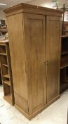 A 19th Century French pine two door wardrobe with hanging space and drawers