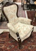 A pair of stained beech framed upholstered scroll arm chairs