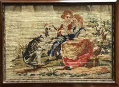 A Victorian needlework tapestry of a couple with large dog in a landscape,