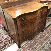 A late George III mahogany serpentine fronted chest of four long graduated drawers on bracket feet