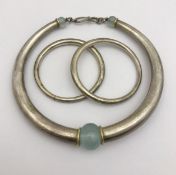A Poppy Dandiya torque style necklace set with three hardstone beads,