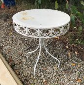 A white painted circular metal garden table