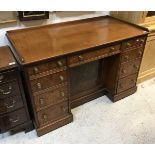 A Victorian burr walnut veneered kneehole desk by Morison & Co of Edinburgh (central drawer