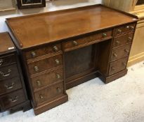 A Victorian burr walnut veneered kneehole desk by Morison & Co of Edinburgh (central drawer