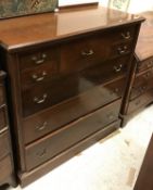 A circa 1900 mahogany chest with central bonnet drawer flanked by two pairs of small drawers over