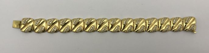An 18 carat gold bracelet with square links, each set with diamonds,
