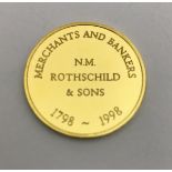 A 14 carat gold medallion inscribed "Merchant and Bankers N.