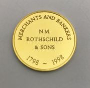 A 14 carat gold medallion inscribed "Merchant and Bankers N.