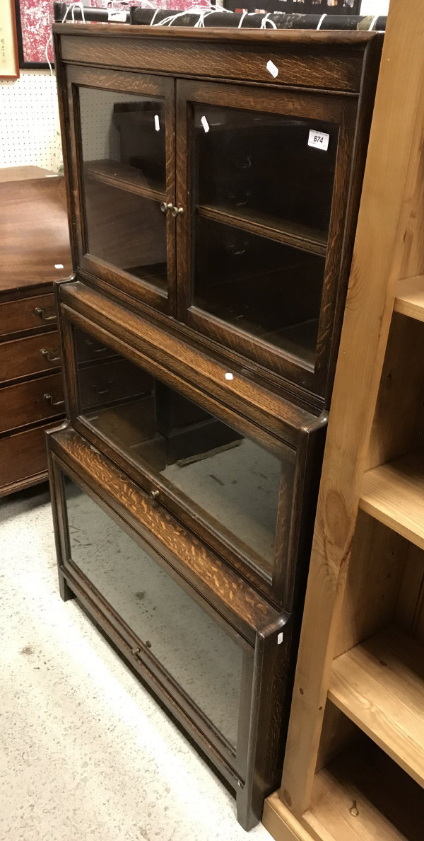 An early 20th Century Gunn three section bookcase with two glazed doors over two further glass