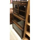 An early 20th Century Gunn three section bookcase with two glazed doors over two further glass