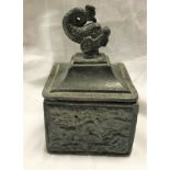 A 19th Century lead tobacco container, the lid with dolphin finial,