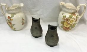 A pair of Art Nouveau patinated spelter vases and a pair of pottery toilet jugs