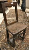 An 18th Century oak back stool,