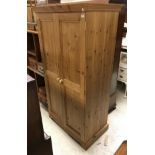 A modern pine two door wardrobe and a Victorian mahogany twelve section stick stand