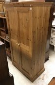 A modern pine two door wardrobe and a Victorian mahogany twelve section stick stand