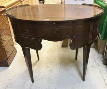 An early 19th Century French mahogany and brass inlaid oval writing table,