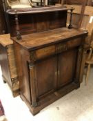 A Regency rosewood chiffonier with shelved superstructure over two drawers and two cupboard doors