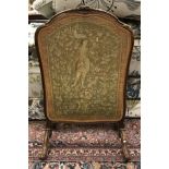 An early 20th Century walnut framed fire screen in the Louis XV taste with gros and petit point