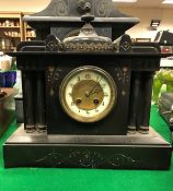 A 19th Century French black marble cased mantel clock of architectural form with eight day movement