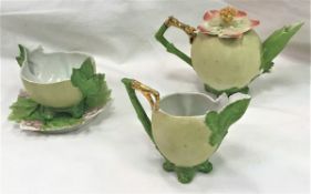 A circa 1900 Japanese biscuit fired "Peach" part tea set comprising teapot, sugar bowl,