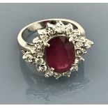 An 18 carat white gold set ruby and diamond cluster ring