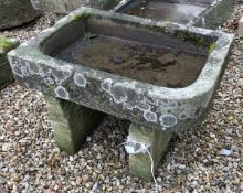 A natural stone trough with single rounded corner
