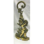 A brass cherubic doorstop in the Rococo style,