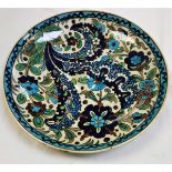 A Burmantofts faience charger, floral decorated in the Middle Eastern taste in blues,