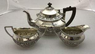 An Indian three piece tea set comprising teapot, sugar bowl and milk jug,