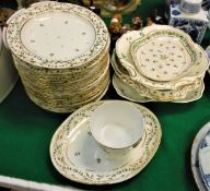 A set of sixteen early 19th Century Derby polychrome floral and gilt decorated plates and an oval