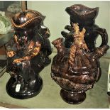 A pair of 19th Century treacle glazed pottery jugs as snuff-taking Toby Philipott,