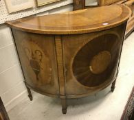 A 19th Century walnut and inlaid demi-lune cabinet in the Sheraton style,