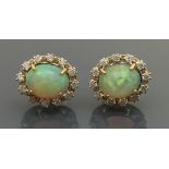 A pair of 18 carat gold opal and diamond set cluster earrings