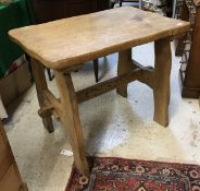 A rustic elm occasional table, the shaped top on similarly shaped supports,