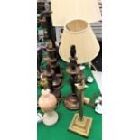 A black lacquered and brass column table lamp, a corinthian column brass table lamp,